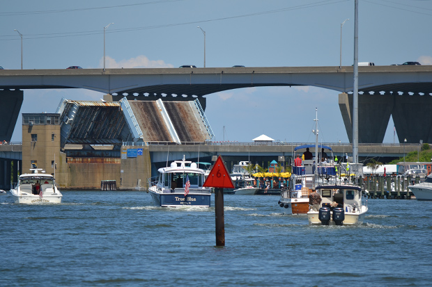 Kent Narrows was busy by our arrival, boats headed north and south waited for the bridge while patrons enjoyed lunch at the Big Owl, 01JUN14